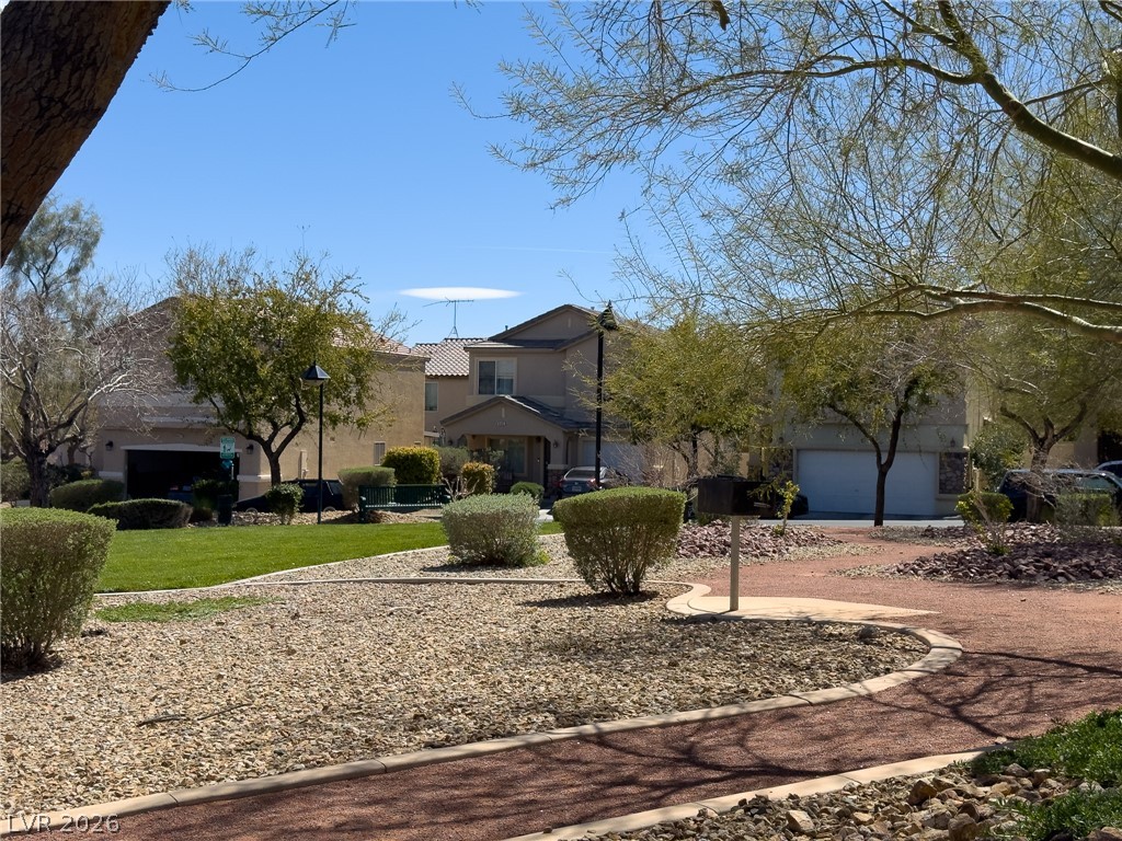 9456 Grandview Spring Avenue Las Vegas, NV 89166 - Photo 45 of 49 A well-maintained neighborhood green space with manicured landscaping and inviting residential homes.