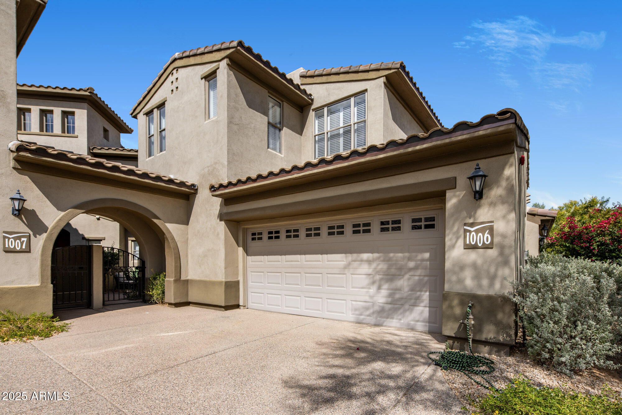 a view of a grey house with large windows