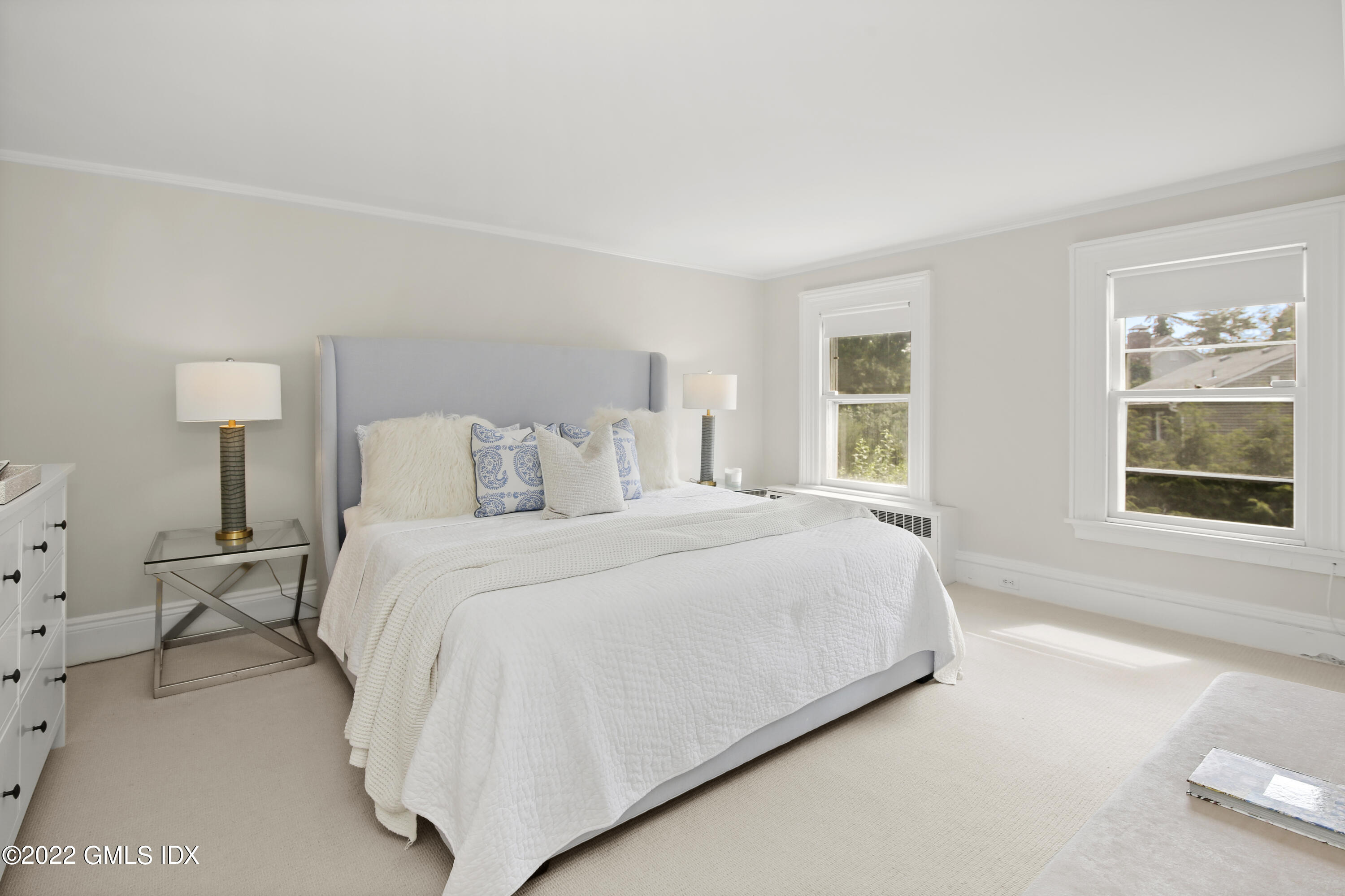 123 Riverside Avenue Riverside, CT 06878 - Photo 10 of 23 a bedroom with a bed and lamp with window