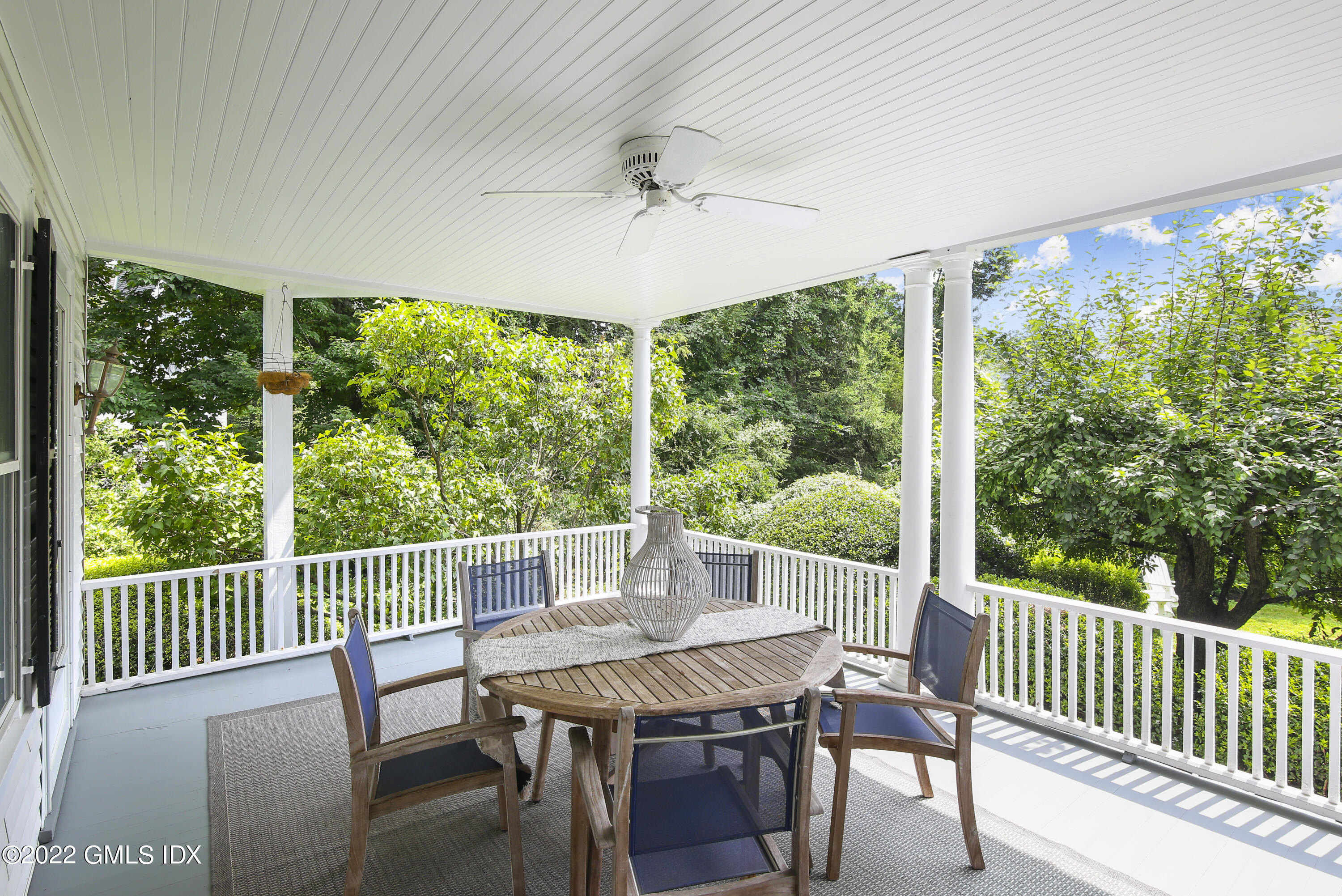 123 Riverside Avenue Riverside, CT 06878 - Photo 17 of 23 a view of a patio with a table chairs and a porch