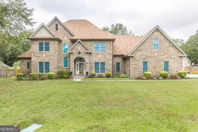 a front view of a house with garden