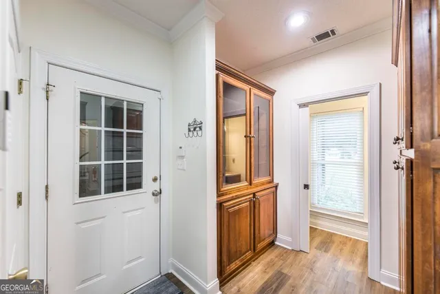 a view of empty room with a window and wooden floor
