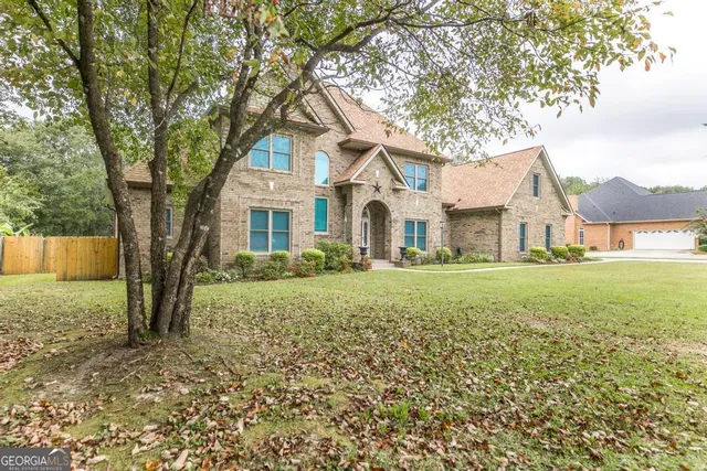 a front view of a house with a yard