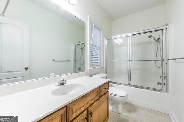 a bathroom with a sink toilet vanity and shower