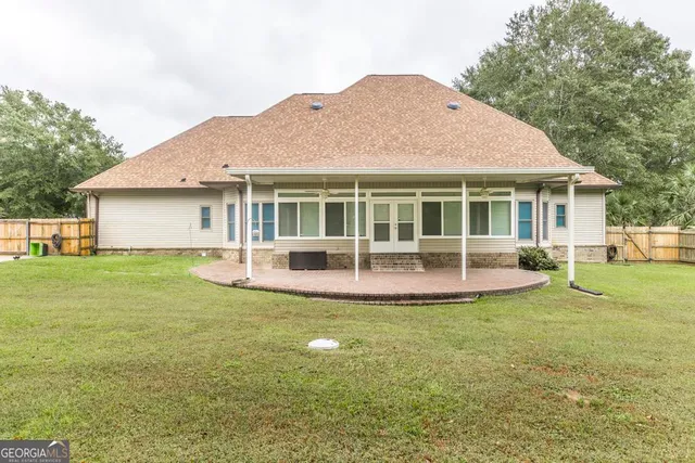 a view of a house with a yard and sitting area
