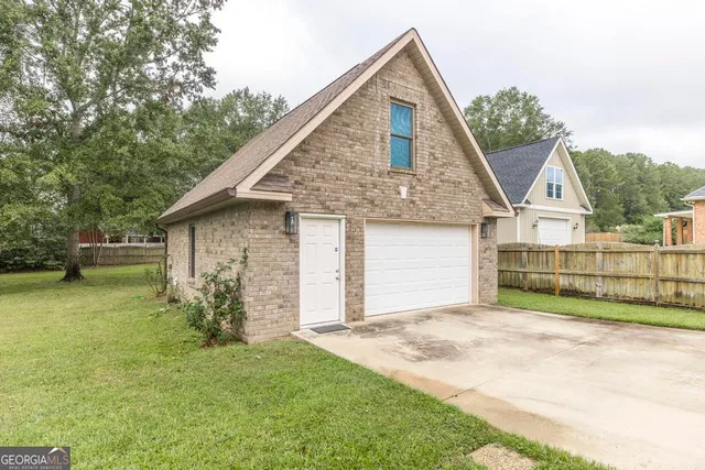 a view of a house with a yard and garage