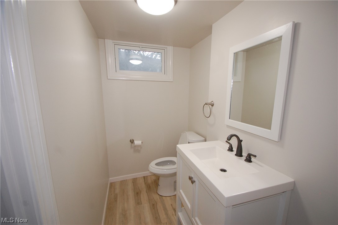 408 Ewing Road Youngstown, OH 44512 - Photo 30 of 31 Bathroom with light hardwood flooring, mirror, and vanity