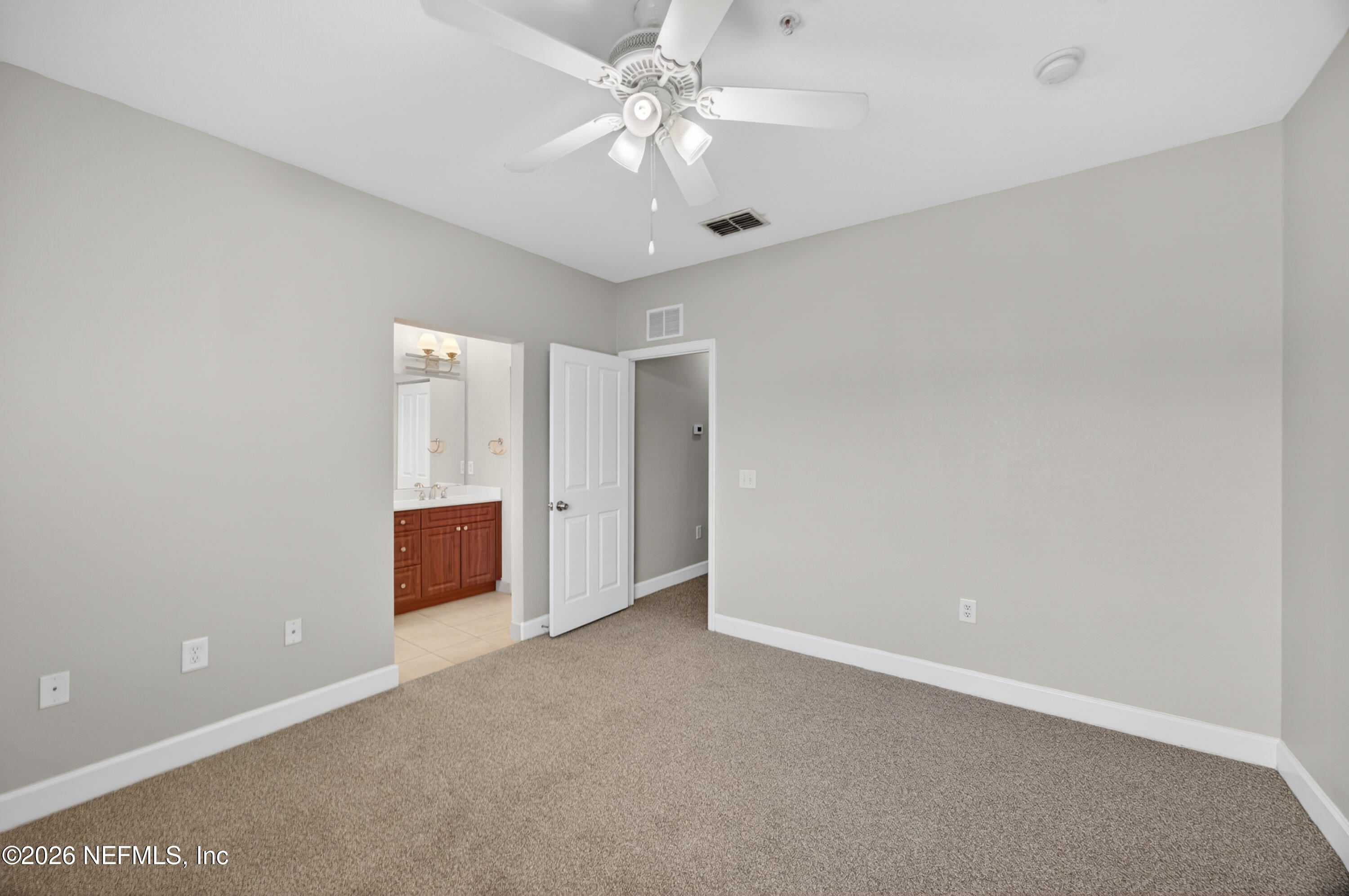9745 Touchton Road, Unit 1224 Jacksonville, FL 32246 - Photo 13 of 22 a view of an empty room with a ceiling fan