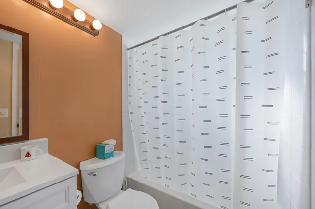 a white toilet sitting next to a bathroom sink