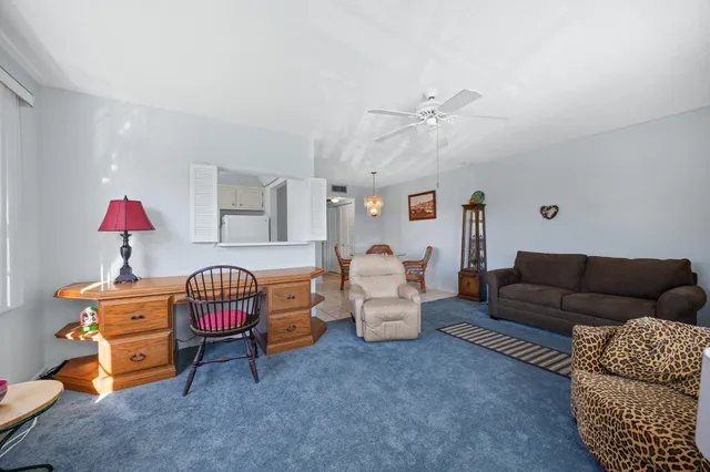 a living room with furniture and a gym machine