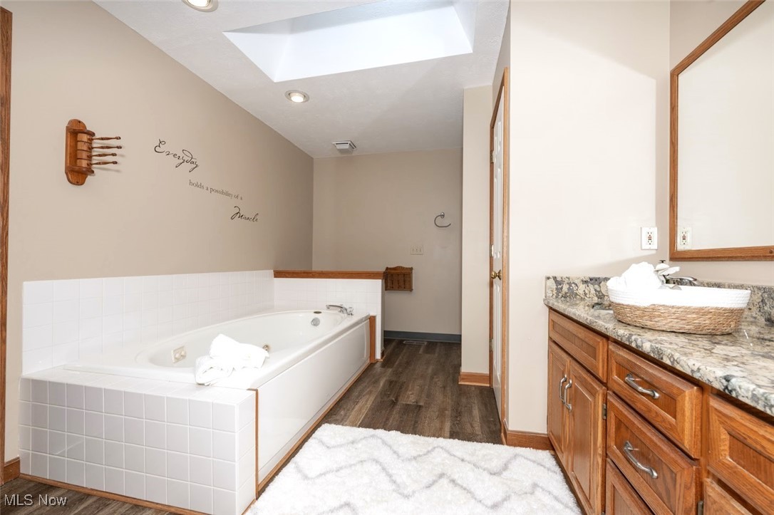 452 Herbert Road Akron, OH 44312 - Photo 26 of 48 *MASTER ENSUITE FULL BATHROOM W/NEW LVP FLOORING, GRANITE COUNTERTOPS, HIS/HER SINK, SKYLIGHT, JETTED SUNKEN TUB, WALK IN SHOWER AND WALK IN CLOSET