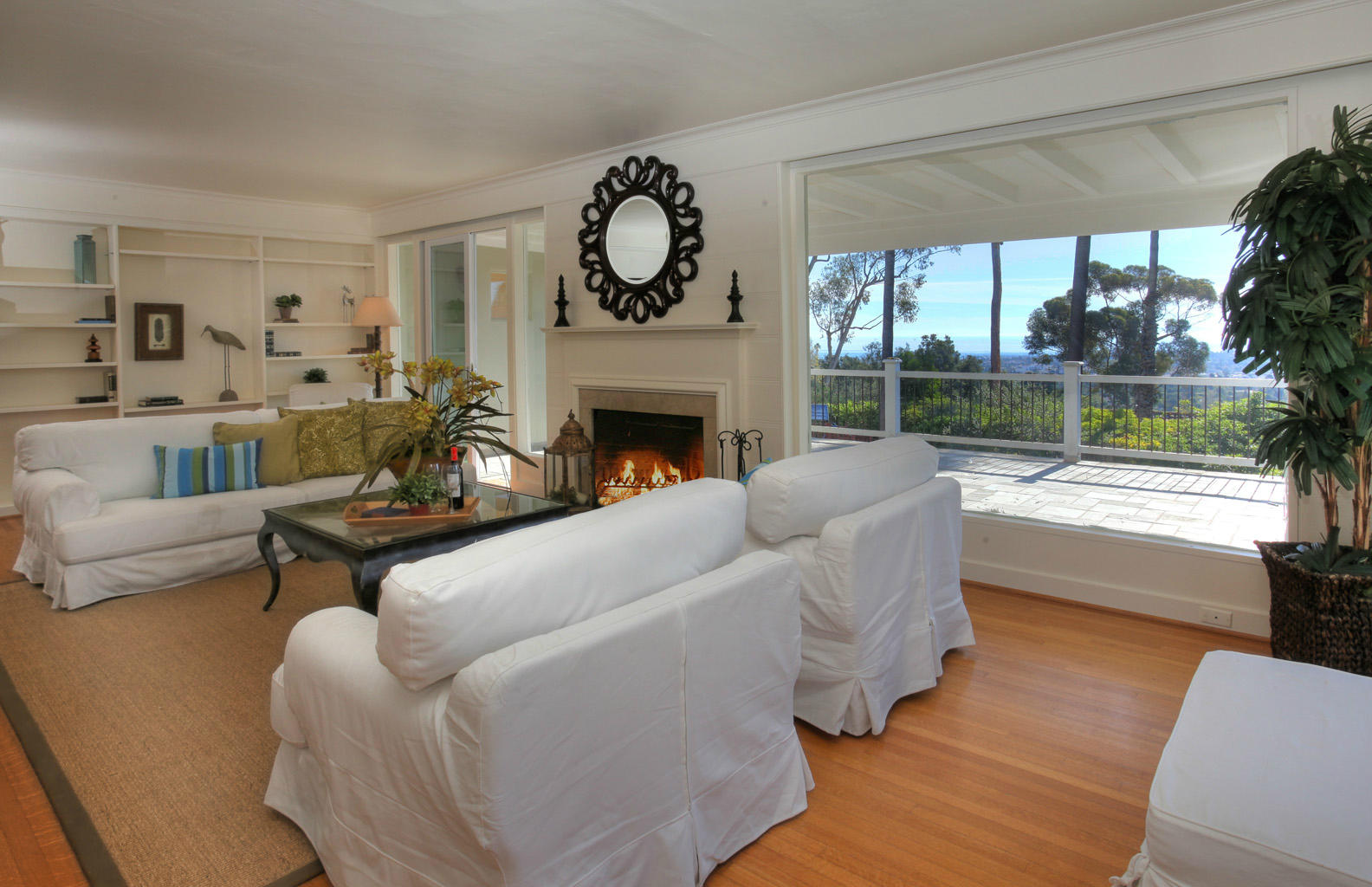 2135 Ridge Lane Santa Barbara, CA 93103 - Photo 3 of 15 a living room with furniture a fireplace and floor to ceiling windows
