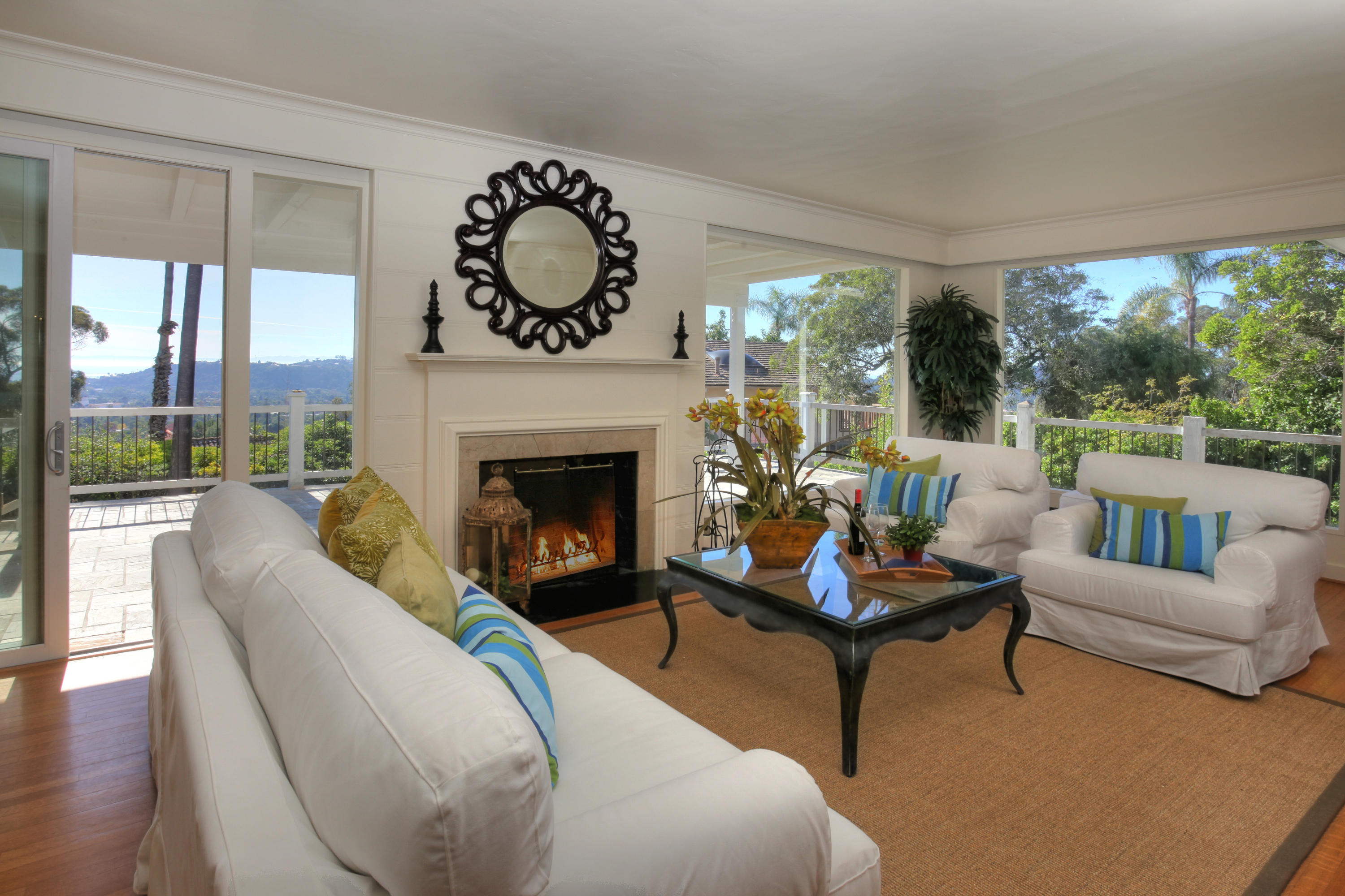 2135 Ridge Lane Santa Barbara, CA 93103 - Photo 4 of 15 a living room with furniture a fireplace and floor to ceiling windows