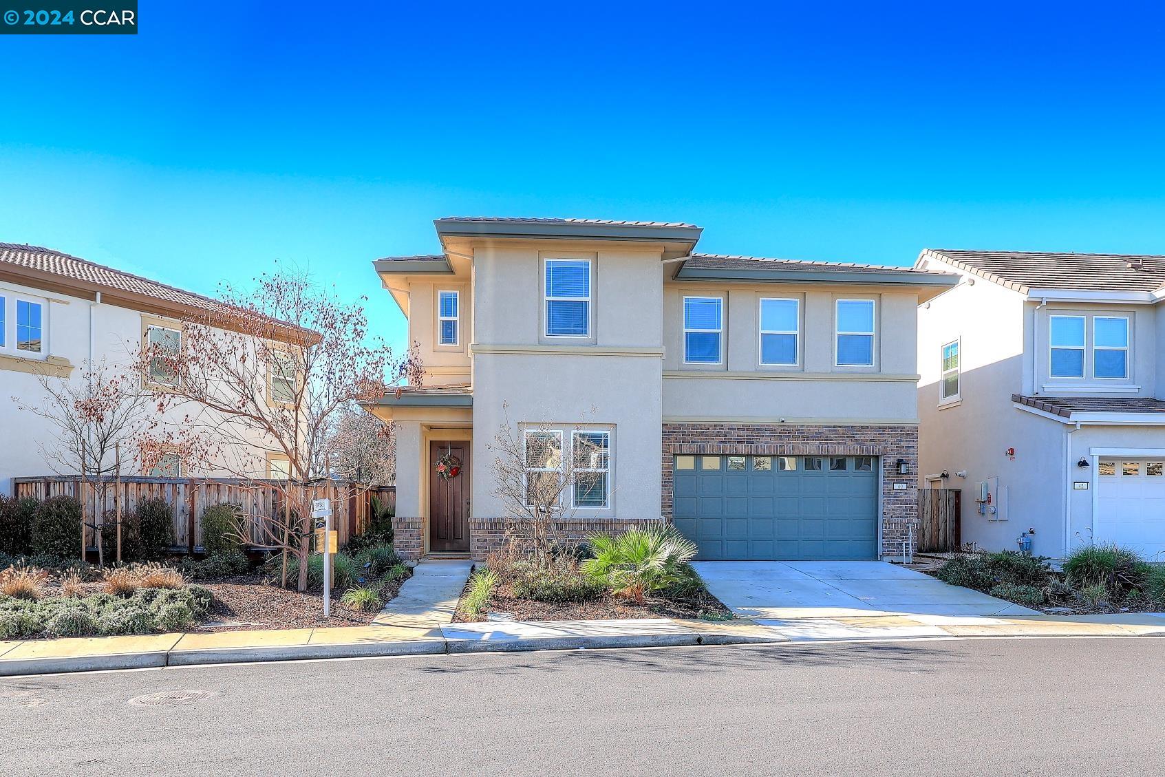 a front view of a house with a garden