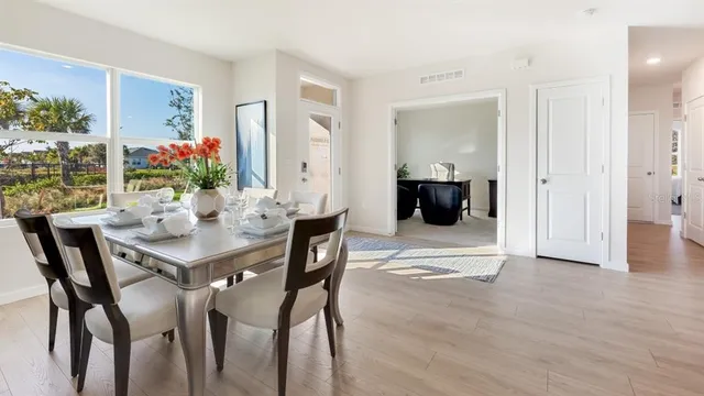 a dining room with furniture and wooden floor