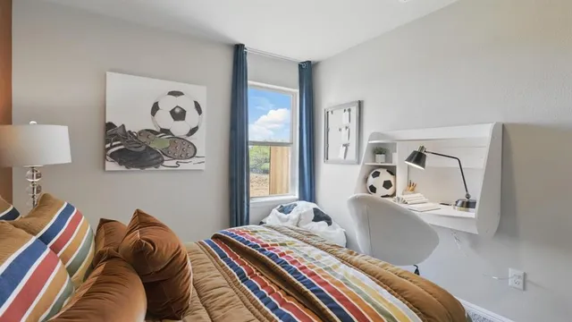 a bedroom with a large bed and a window