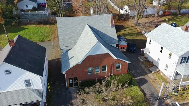 an aerial view of a house with garden space and street view