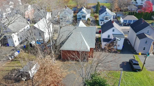 an aerial view of a house with a yard