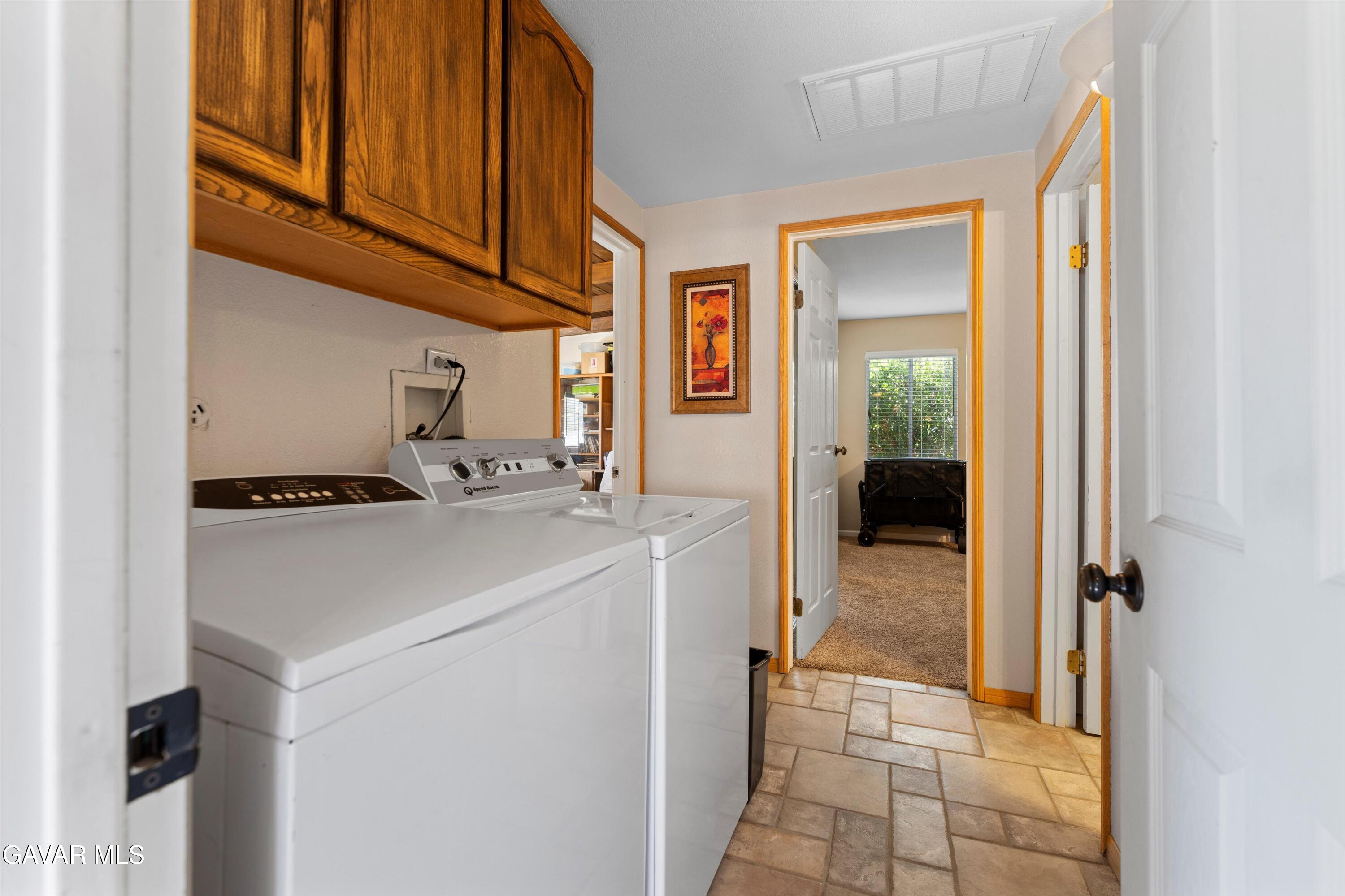 42409 12th Street West Lancaster, CA 93534 - Photo 11 of 20 a view of hallway with washer and dryer