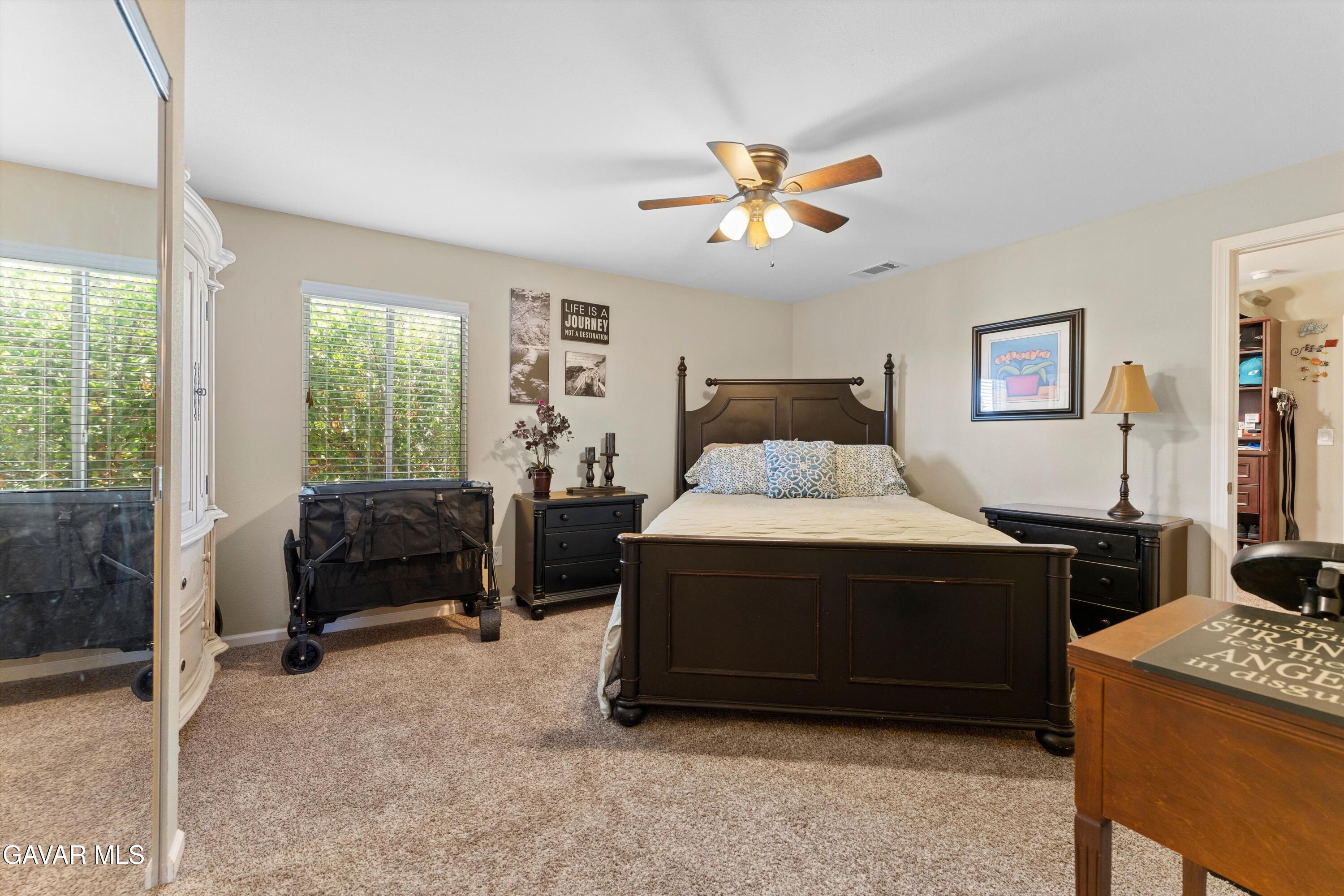 42409 12th Street West Lancaster, CA 93534 - Photo 13 of 20 a bedroom with a bed and a chandelier