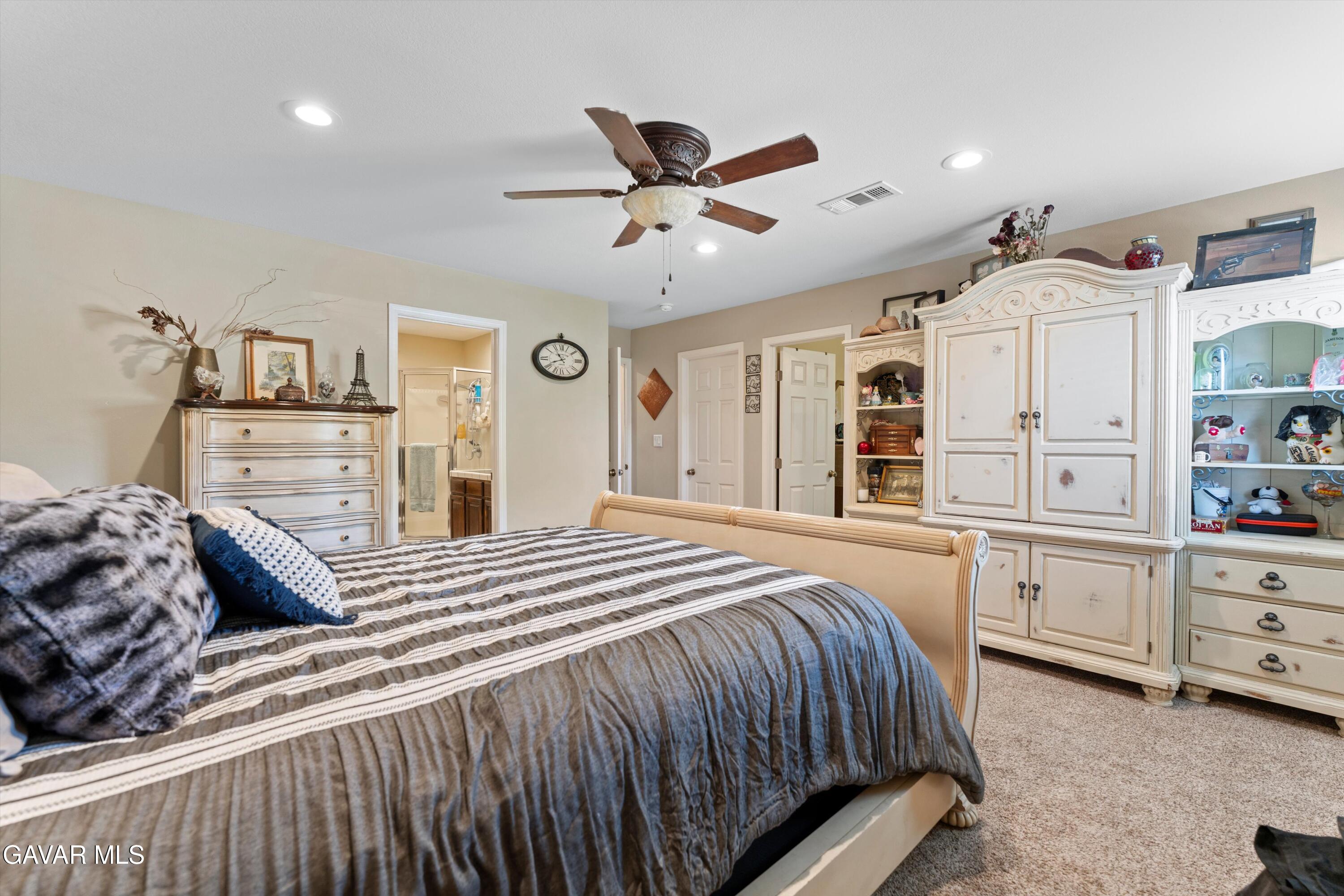 42409 12th Street West Lancaster, CA 93534 - Photo 16 of 20 a bedroom with a bed and cabinets