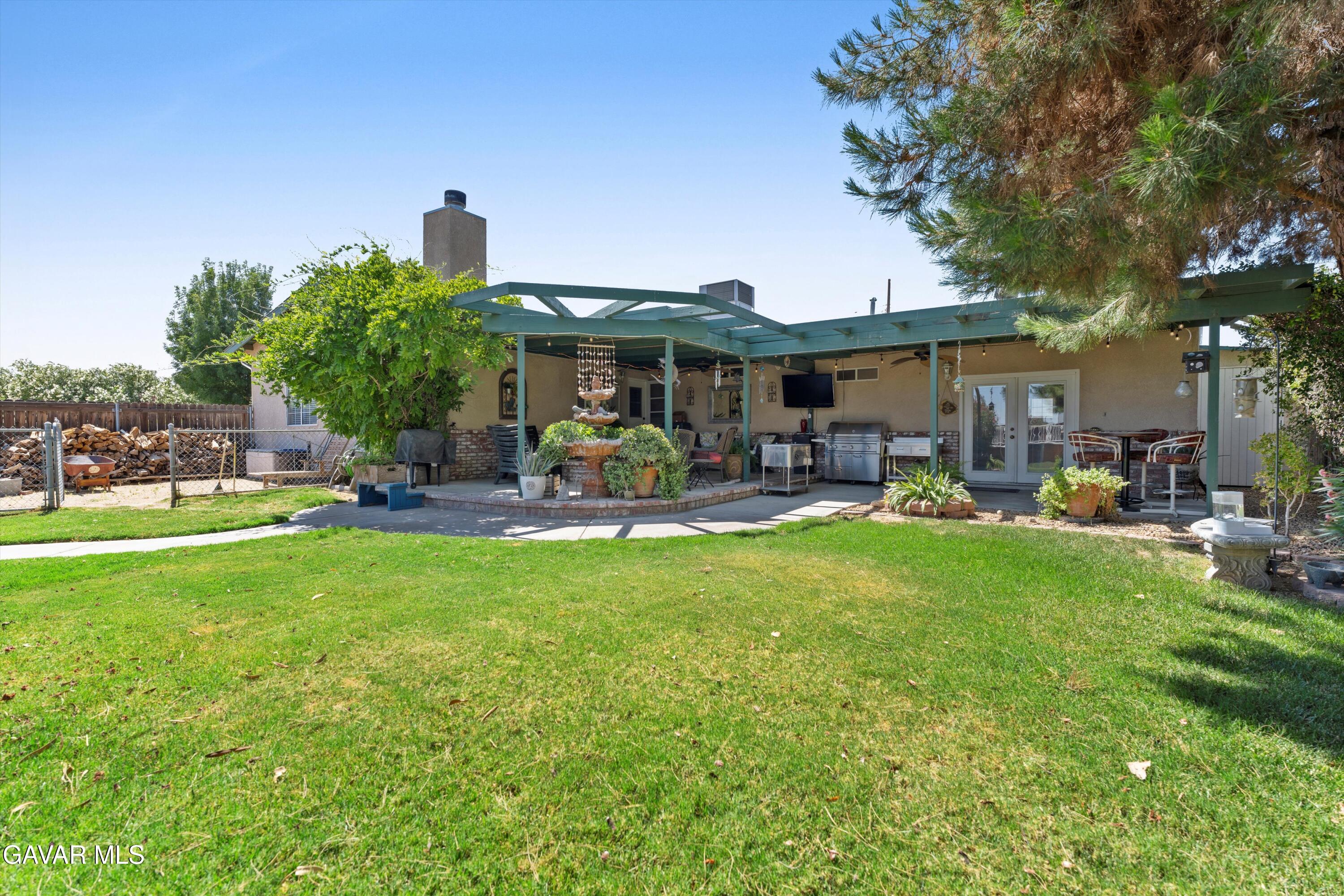 42409 12th Street West Lancaster, CA 93534 - Photo 18 of 20 a front view of a house with garden and sitting area
