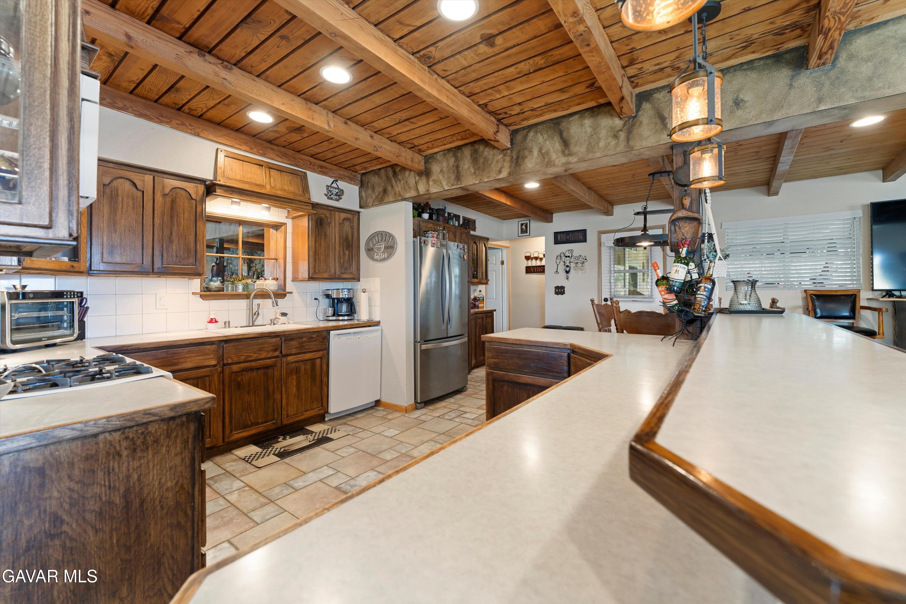 42409 12th Street West Lancaster, CA 93534 - Photo 5 of 20 a kitchen with counter top space a sink appliances and cabinets