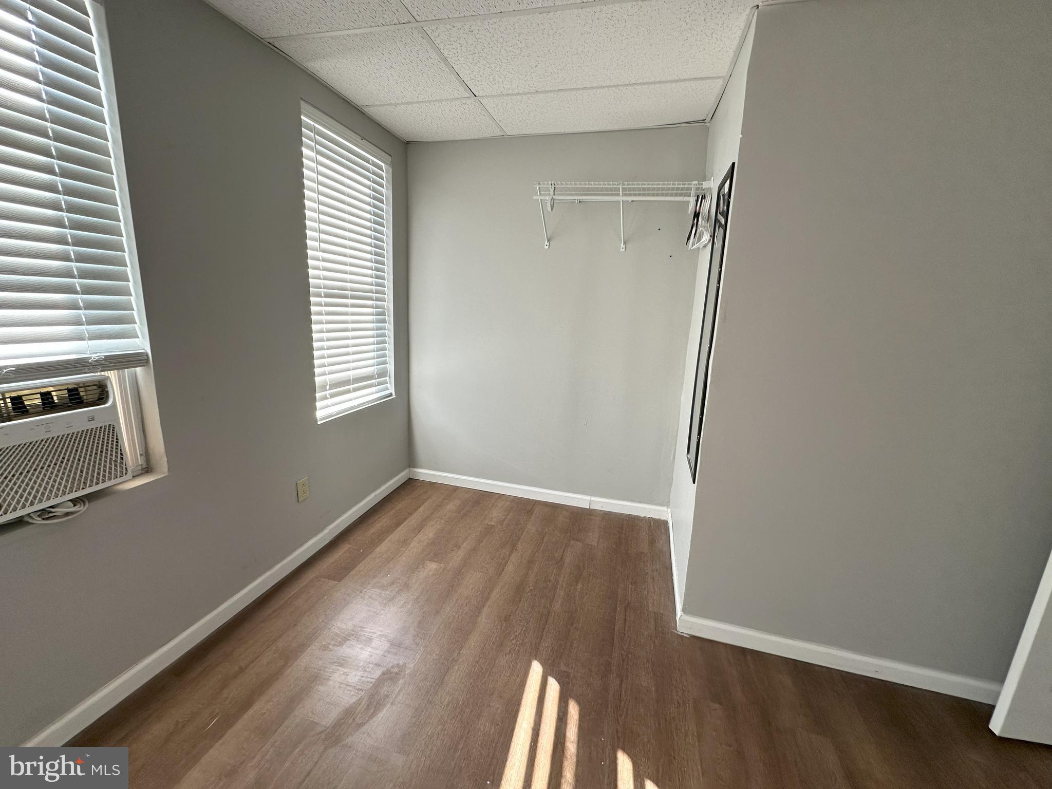 1510 Sycamore Street Curtis Bay, MD 21226 - Photo 12 of 23 an empty room with wooden floor and windows