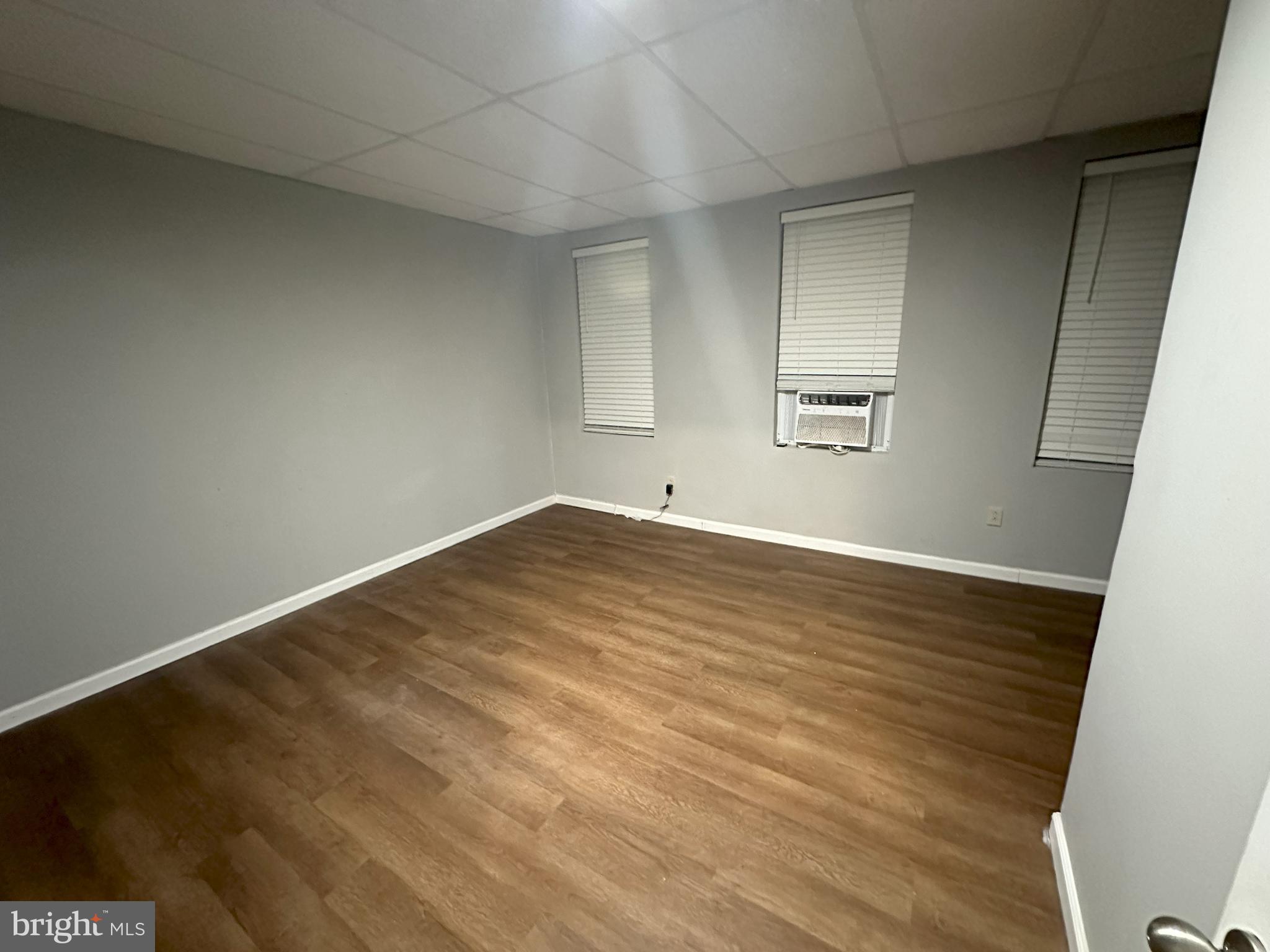 1510 Sycamore Street Curtis Bay, MD 21226 - Photo 13 of 23 an empty room with wooden floor and windows