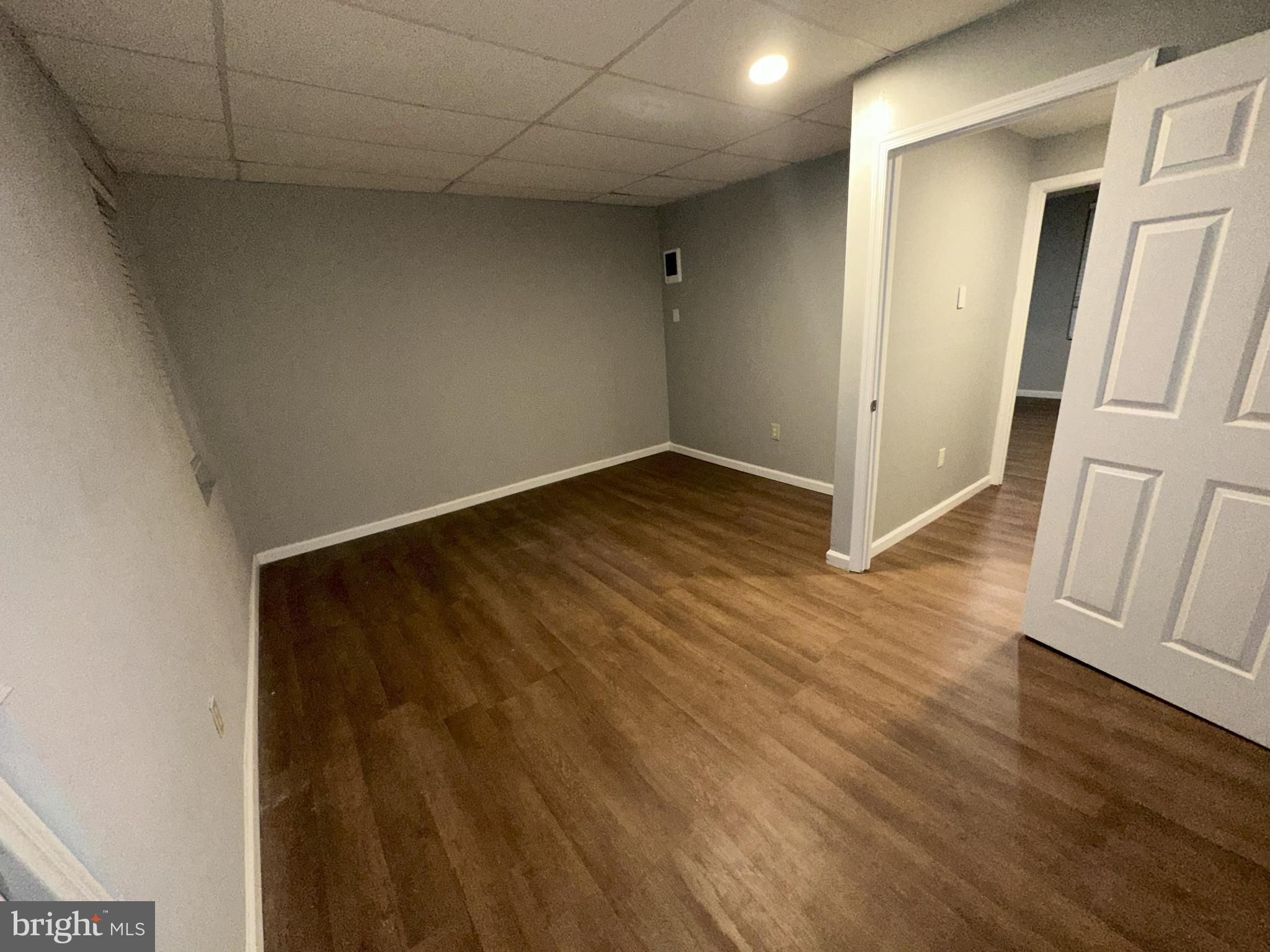 1510 Sycamore Street Curtis Bay, MD 21226 - Photo 18 of 23 an empty room with wooden floor and entrance