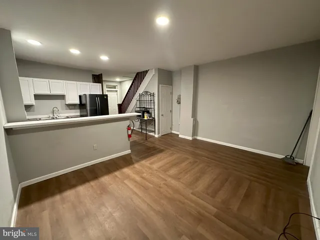 a kitchen with granite countertop a stove and a refrigerator