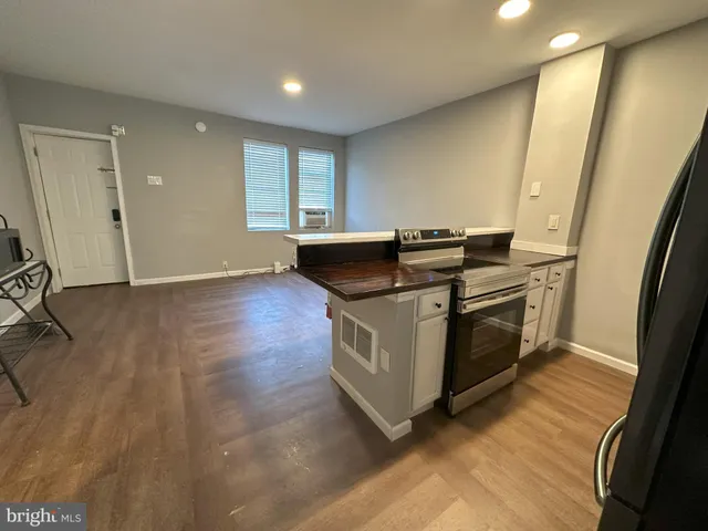 a view of a refrigerator in kitchen and wooden floor