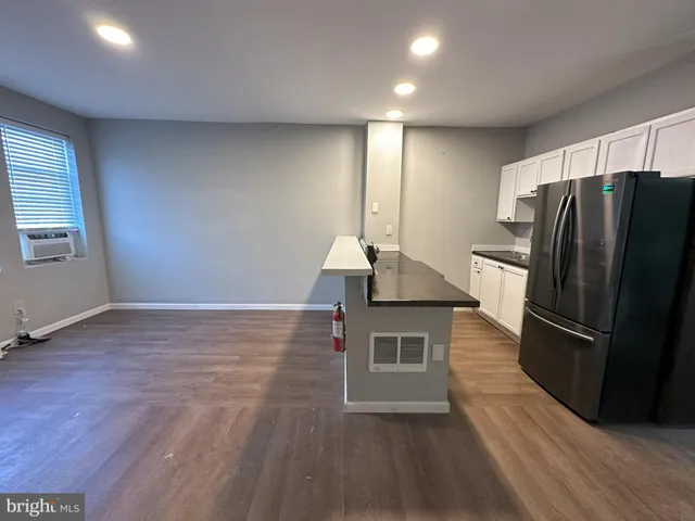 a kitchen with sink a refrigerator and cabinets