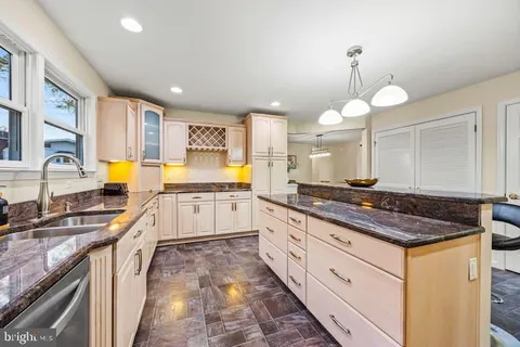 a kitchen with stainless steel appliances granite countertop a stove a sink and a granite counter tops with white countertops
