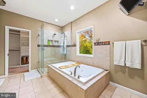 a bathroom with a tub a sink and a shower