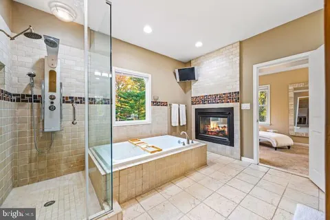 a living room with furniture a fireplace and a table