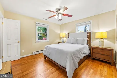a spacious bedroom with a bed and a chandelier
