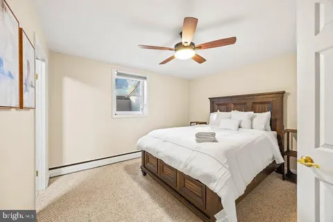 a bathroom with a granite countertop sink toilet and mirror