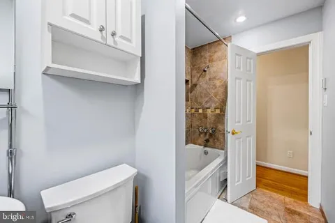 a bedroom with two beds and painting on the wall