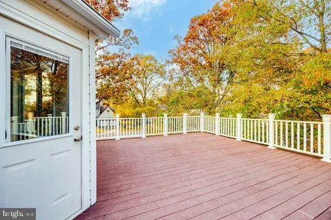 a view of a house with backyard and a tree