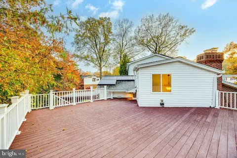 a view of house with outdoor space and trees