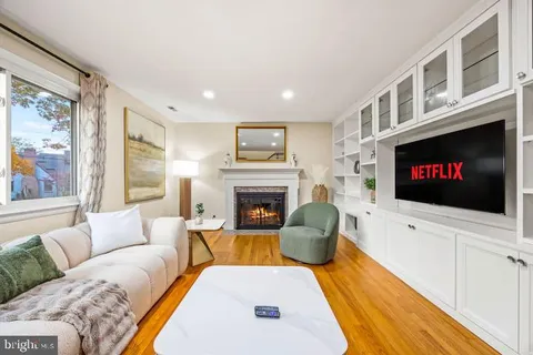 a living room with furniture fireplace and flat screen tv