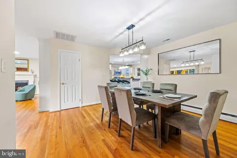 a view of a dining room with furniture wooden floor and chandelier