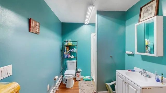 a bathroom with a sink a toilet and a large mirror