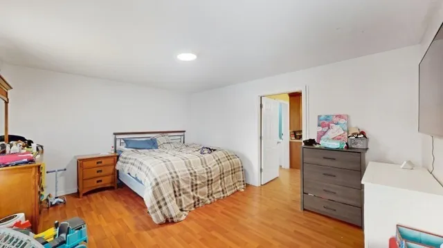 a bedroom with a bed and dresser