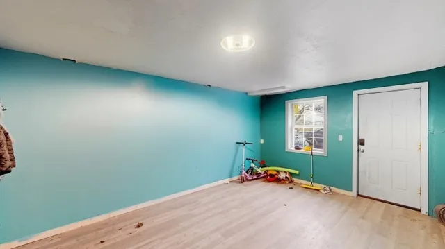 an empty room with closet and windows