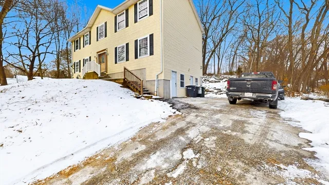 a car parked in front of a white house