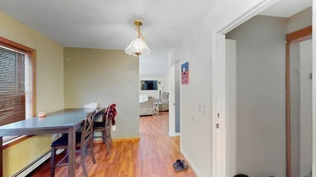 a view of a dining room with furniture wooden floor and a chandelier