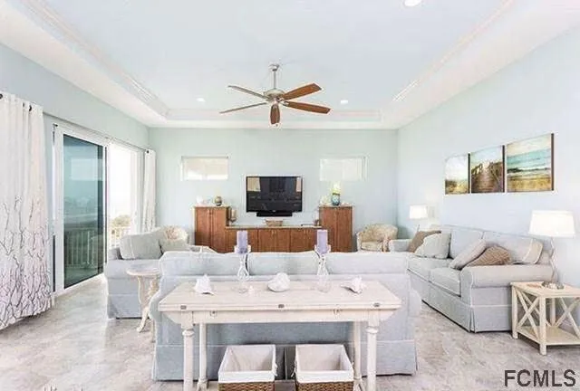 a living room with furniture a flat screen tv and a large window