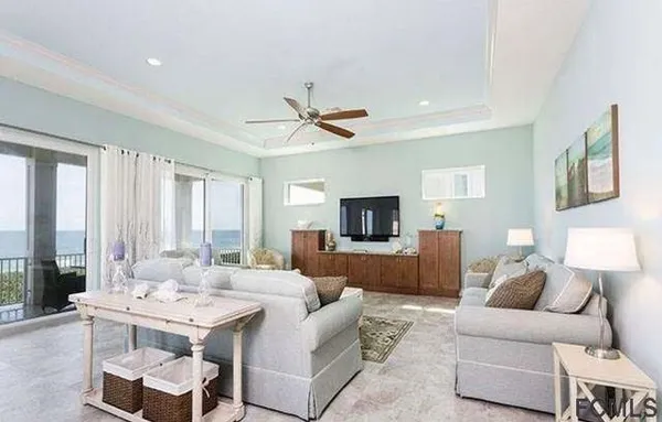 a living room with furniture a large window and a flat screen tv